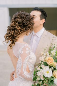 the bride and groom are kissing each other