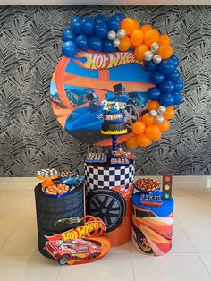 an assortment of balloons and decorations for a hot wheels birthday party