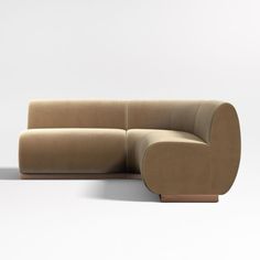 a tan couch sitting on top of a white floor