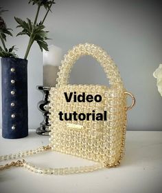 Learn to bead a gorgeous handbag with 500 grams of square acrylic beads in 1 hour and 15 minutes.  You will receive a PDF document with all the required information as well as a YouTube link to the detailed video tutorial.  How to start beading - KNOTS TECHNIQUE How to replace your finished thread Two ways of attaching the 'O' rings How to make the lid How to bead that super tactile handle As a bonus you will receive another video with lots of information about the types of bag beading acrylic b Beaded Handbag Tutorial, Beaded Top Handle Bag For Shopping, Cheap Beaded Square Bags, Pearl Beaded Bag Pattern, Trendy Beaded Square Bag, Luxury Square Beaded Bags, Luxury Beaded Square Bags, Handbag Tutorial, Fishing Line