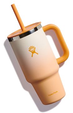 an orange and white coffee cup with a straw in it