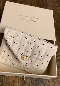 a white and black polka dot purse in a box