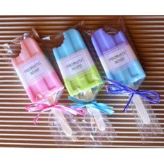 three different colored soaps wrapped in plastic