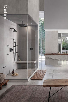 a large bathroom with a walk in shower next to a wooden table and bench on the floor