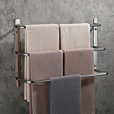 three towels are hanging on a towel rack