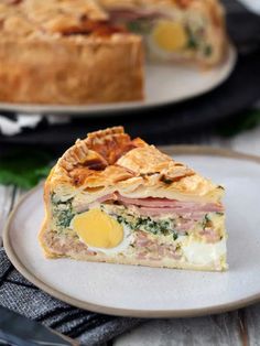 a slice of ham and egg quiche on a plate