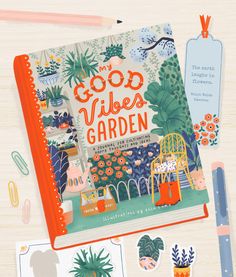 an open notebook with the words good vibes garden on it next to various stickers and magnets