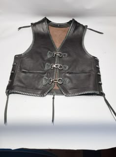 "This vest is suitable for anyone who wants to stand out from the crowd. Motorcyclists are excited and satisfied. Most of them are sewn with sequins from moto choirs. The vest is handmade from extremely high quality leather and has a beautiful braid at the edges. Completely comfortable and easy to carry. Inside, there are 2 large pockets on each side. They are very enthusiastic about our work. The most important thing for us is to satisfy our customers. If you have any questions about my product Moto Vest For Biker Events, Fitted Sleeveless Biker Jacket For Biker Events, Fitted Sleeveless Biker Jacket For Events, Black Fitted Moto Vest, Fitted Moto Vest For Winter, Fitted Winter Motorcycling Vest, Festival Biker Jacket, Moto Style Vest For Biker Events In Fall, Fitted Biker Jacket For Festivals