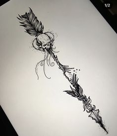 a drawing of a feather and skull on paper