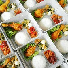 there are many different types of food in the boxes on the table, including rice balls and vegetables