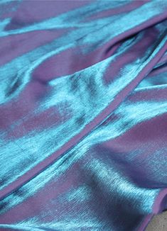 a purple and blue fabric laying on top of each other