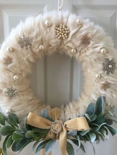 a white wreath hanging on the front door