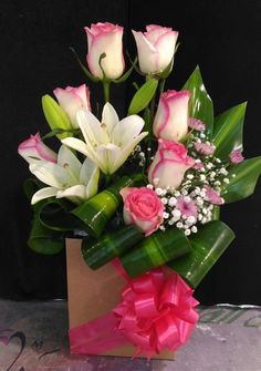 pink and white flowers are in a vase