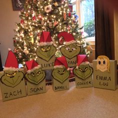 the grinch boxes are sitting in front of a christmas tree