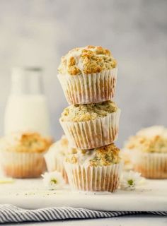 three muffins stacked on top of each other next to a bottle of milk