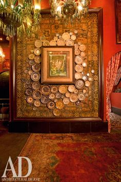 an ornately decorated room with red walls and chandelier hanging from the ceiling