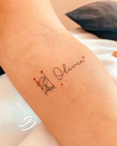 a woman's arm with the word love written on it in cursive writing