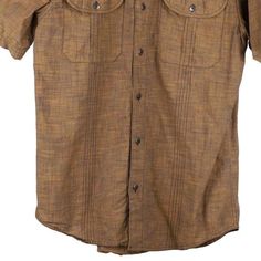 a brown shirt with buttons on the chest