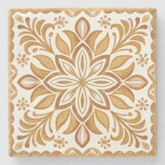 a square tile with an intricate design on it