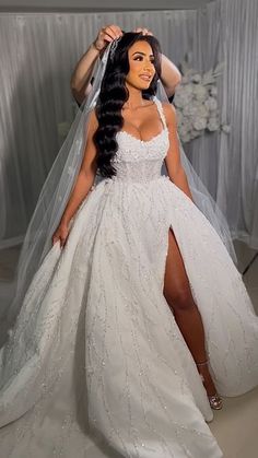 a woman in a white wedding dress is posing for the camera with her long black hair