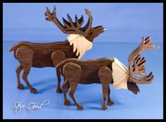 three wooden moose figurines on a blue background