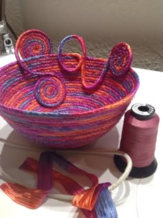 a basket with yarn and thread on the table