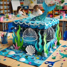 an ocean themed classroom is decorated with paper and crafting supplies for children to make