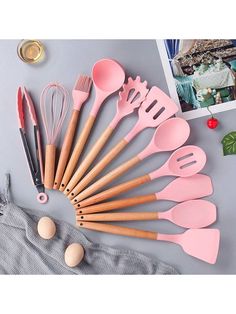 the kitchen utensils are lined up on top of each other, with spoons and spatulas next to them