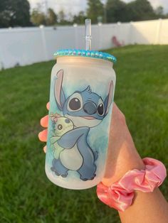 someone holding up a cup with an image of stitching on the outside and inside