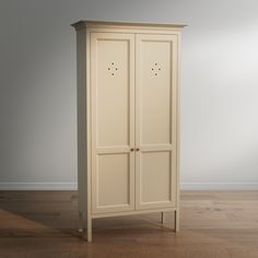 a tall white cabinet sitting on top of a hard wood floor next to a wall