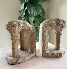 two stone arches sitting on top of a table