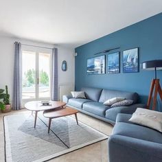 a living room with blue walls and furniture