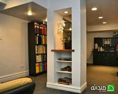 a living room filled with furniture and a book shelf