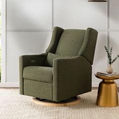 a green recliner chair sitting on top of a rug next to a small table