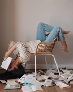 a woman laying on the floor reading a book