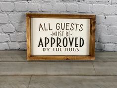 a sign that says, all guests must be approved by the dogs