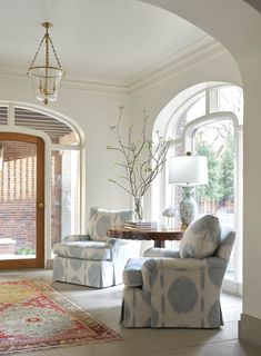 a living room filled with furniture and windows