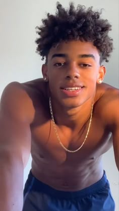 a young man with no shirt on posing for the camera