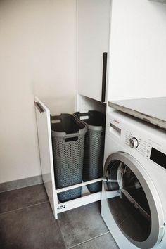 a washer and dryer sitting in a room next to each other on the floor