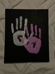 a black and pink handprint on a white sheet