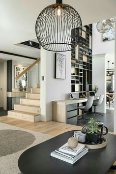 a living room filled with furniture next to a staircase