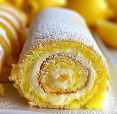 there is a lemon roll with icing on the plate