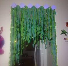 the green curtain is hanging over the refrigerator