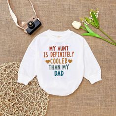 My Aunt is Definitely Cooler Than my Dad , Retro Aunt baby, Aunt Gift Romper, Aunt Funny Romper Sweatshirt, Baby Shower Gift - Handmade  - Ships from USA  - Materials: 100% CPSIA Compliant and Ethically Made material Light fabric (5.0 oz/yd² (170 g/m  Crafted with soft, breathable fabric, this romper ensures your baby stays comfortable through playtimes and nap times alike. Featuring charming designs suitable for all babies, our romper is as adorable as it is practical.  Quick Sizing Tip  Our ro Diy Gifts For Nephew, White Tops With Funny Parenting Text, White Long Sleeve T-shirt With Funny Text, White Long Sleeve Tops With Funny Text, Cute Letter Print Top For First Birthday, Graphic Print Long Sleeve Top For First Birthday, White Cotton Top For First Birthday, Cute Long Sleeve Tops With Funny Text, White Long Sleeve Tops For First Birthday