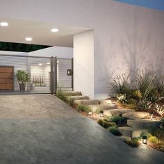 a modern house with an entrance and landscaping