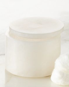 a white container sitting on top of a marble counter