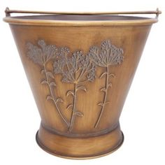 a wooden vase with flowers etched on the side and handles to hold something in it