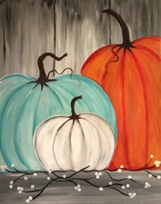 two painted pumpkins sitting on top of a table