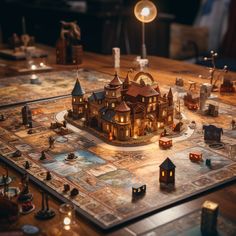 a game board with an elaborate model of a house on it, surrounded by candles and figurines