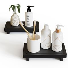 two black trays with white bottles and toothbrushes on them next to each other